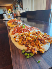 Polenta served "family style" on a polenta board, various toppings